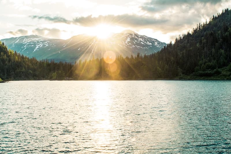 Sunset in Alaska with a lake and mountains